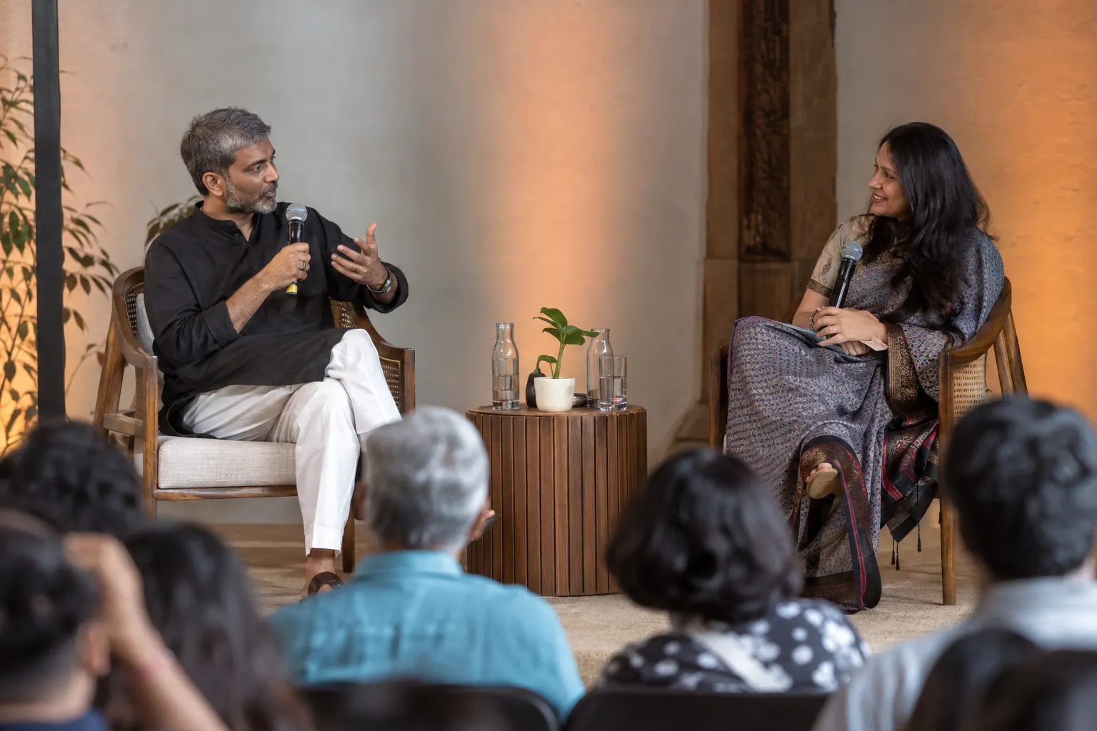 Two professionals in conversation on a small stage